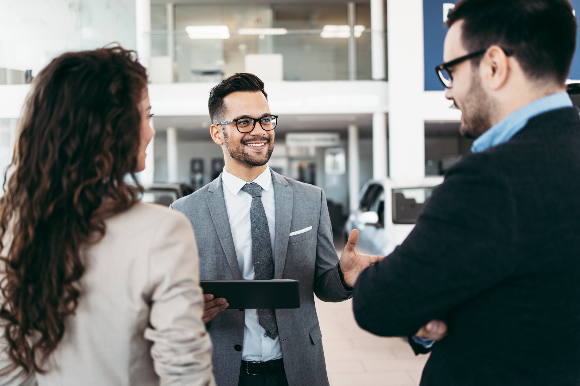 People discussing finances with a dealership employee